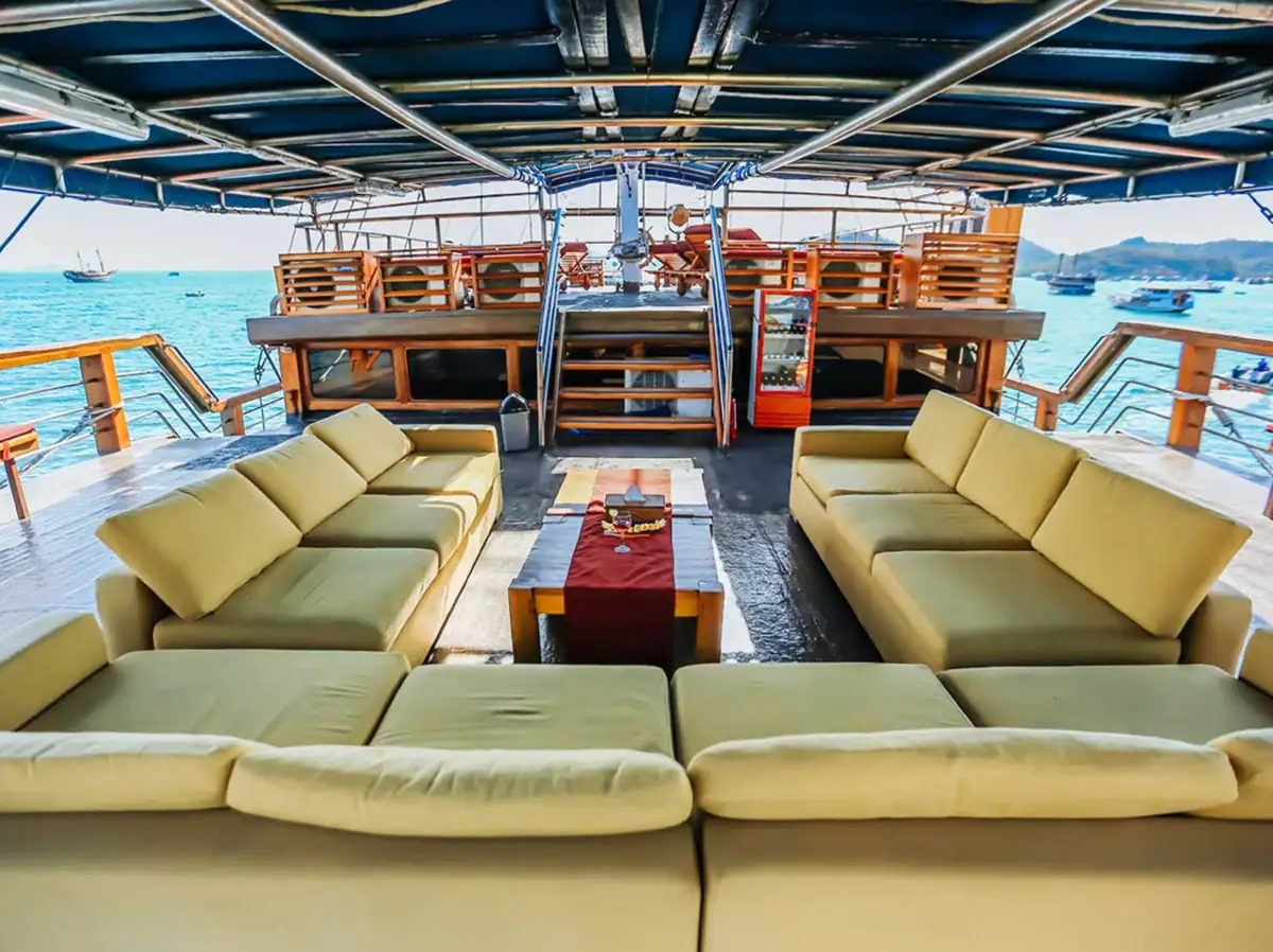 Spacious upper deck lounge on Cheng Ho yacht with cushioned seating and sea views.