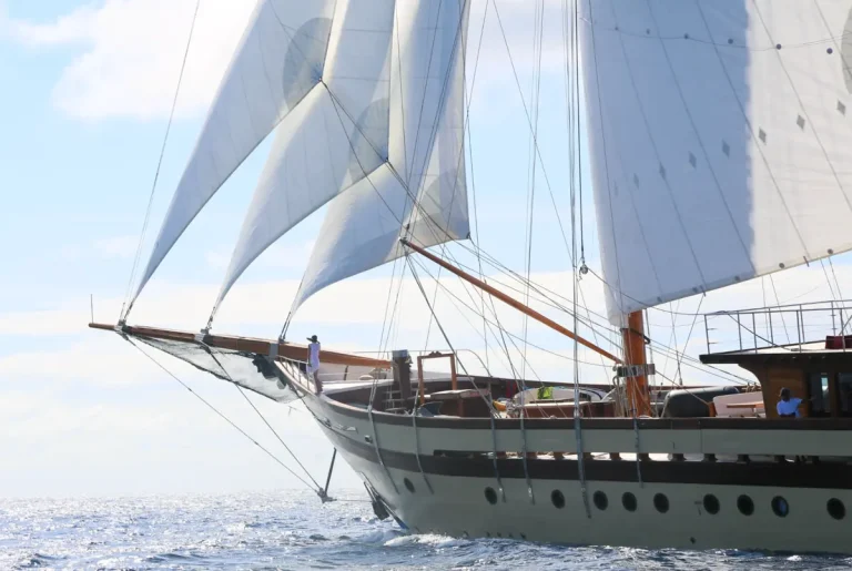 Lamima luxury phinisi yacht sailing through the Indonesian archipelago.