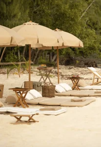 Private beach setup with chairs and umbrellas in Komodo National Park