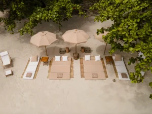 Relaxing and luxury beach setup with umbrellas and loungers in Komodo
