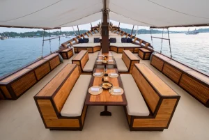 Majik yacht outdoor dining and lounge deck with teak furniture and ocean views.
